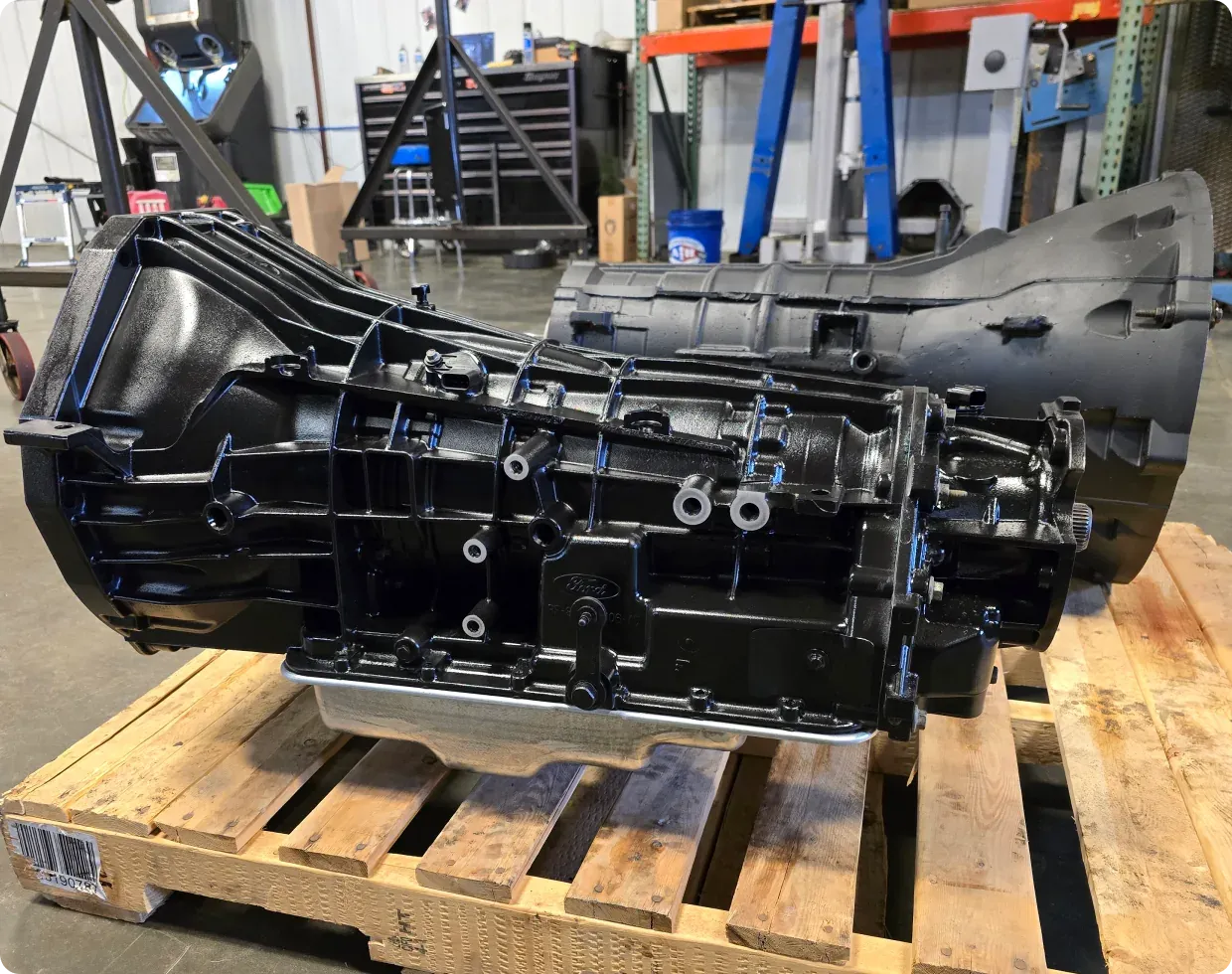 A transmission case on a pallet in the 1023 Diesel & Fleet shop in Palmer, AK, with parts shelves in the background.